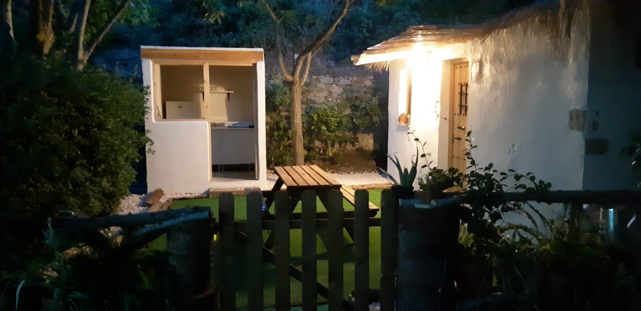 Cabaña iluminada de noche con farolillo