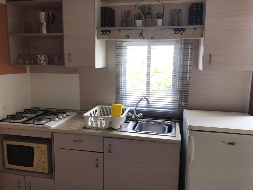 Cocina moderna con microondas y vajilla